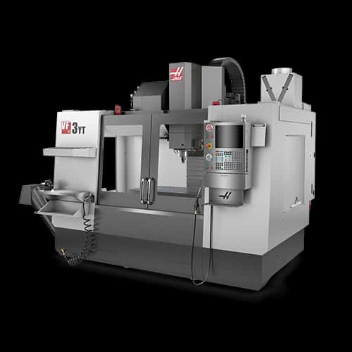 A bright flood light in a dark room revealing machined parts neatly organized on a wooden pallet.